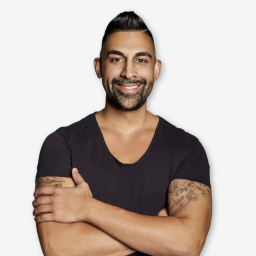 Man with short hair and beard wearing a black T-shirt, crossing his arms and smiling, against a plain white background.